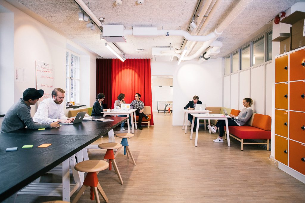 Students and startups collaborating in the kitchen area at Openlab's co-working space.